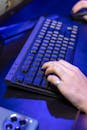 A close-up shot of a person typing on a keyboard, showcasing technology use.